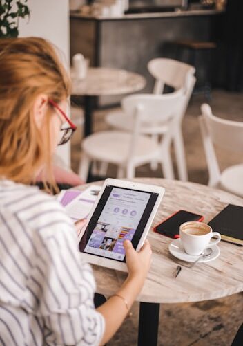 A photo of somebody looking at information on a tablet.