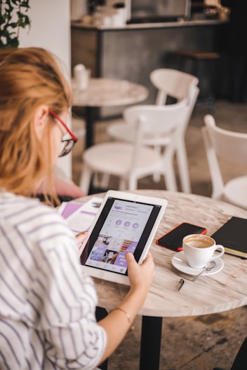 A photo of somebody looking at information on a tablet.