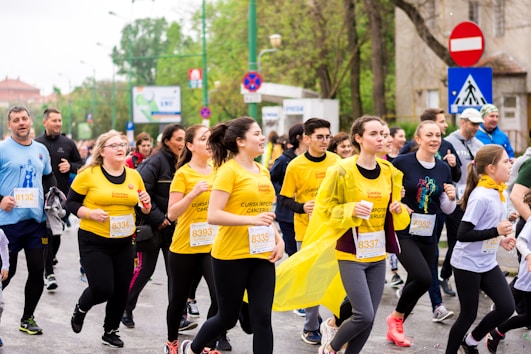 A photo of a group of runners wearing a yellow tshirts. They are fundraising money for charity.