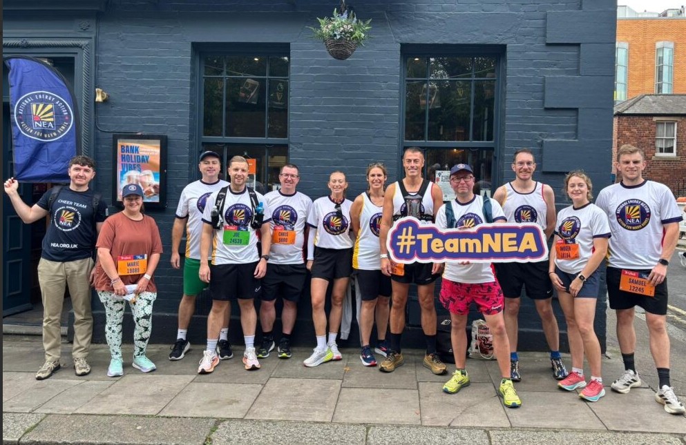 Group picture holding TeamNEA sign after fundraising run