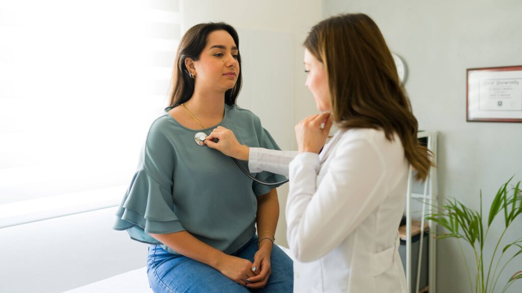 A photo of a doctor using a stethoscope on a patient. 