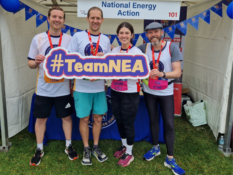 A photo of runners who have completed the Great North Run for National Energy Action. They are holding a sign that says, '#TeamNEA'.