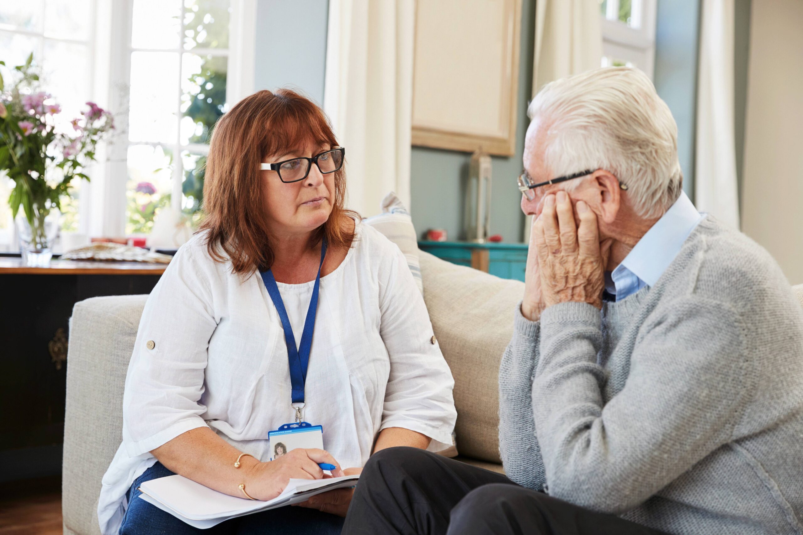 An Energy Adviser speaking to an older male client.