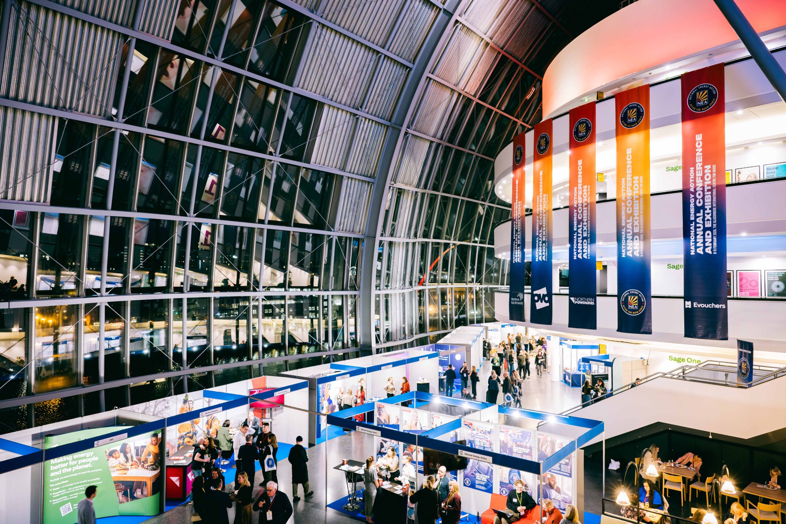 A photo of National Energy Action's annual conference taken at the Glasshouse in Gateshead. Inside the large domed building, you can see an exhibition with our members talking to delegates about how they can help fight fuel poverty.