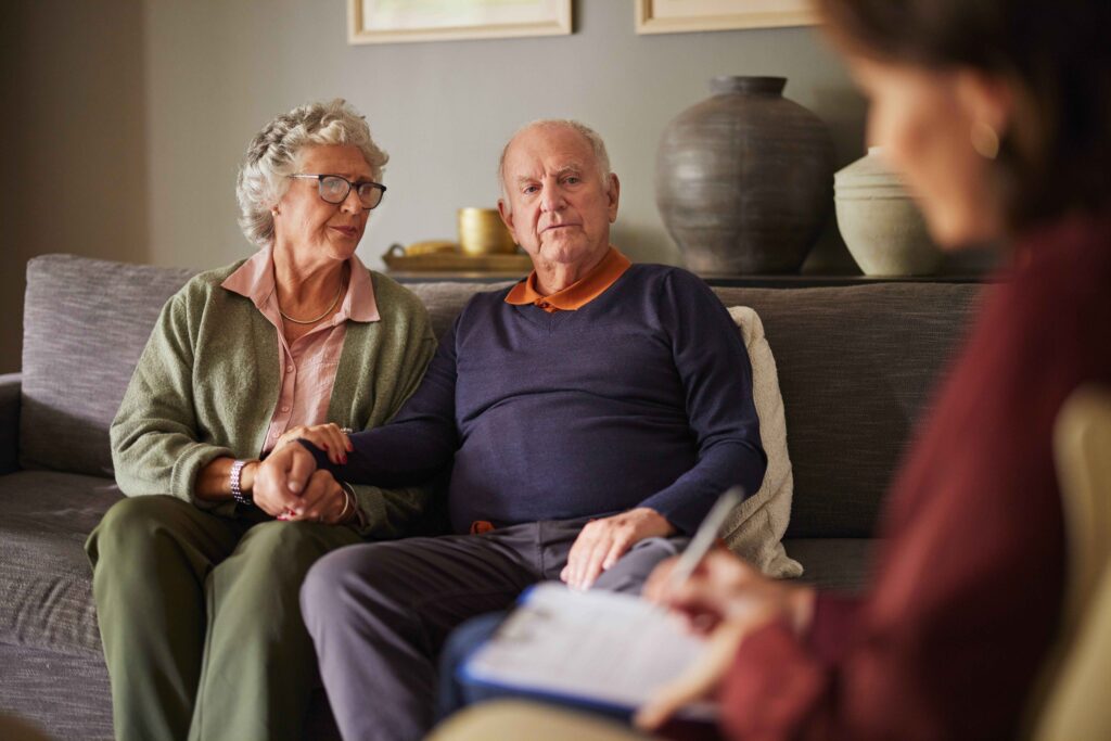 A photo of an elderly couple receiving energy advice at home. 