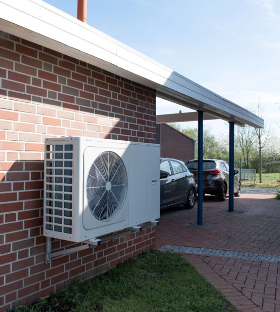 Photo of a heat pump installed on a house