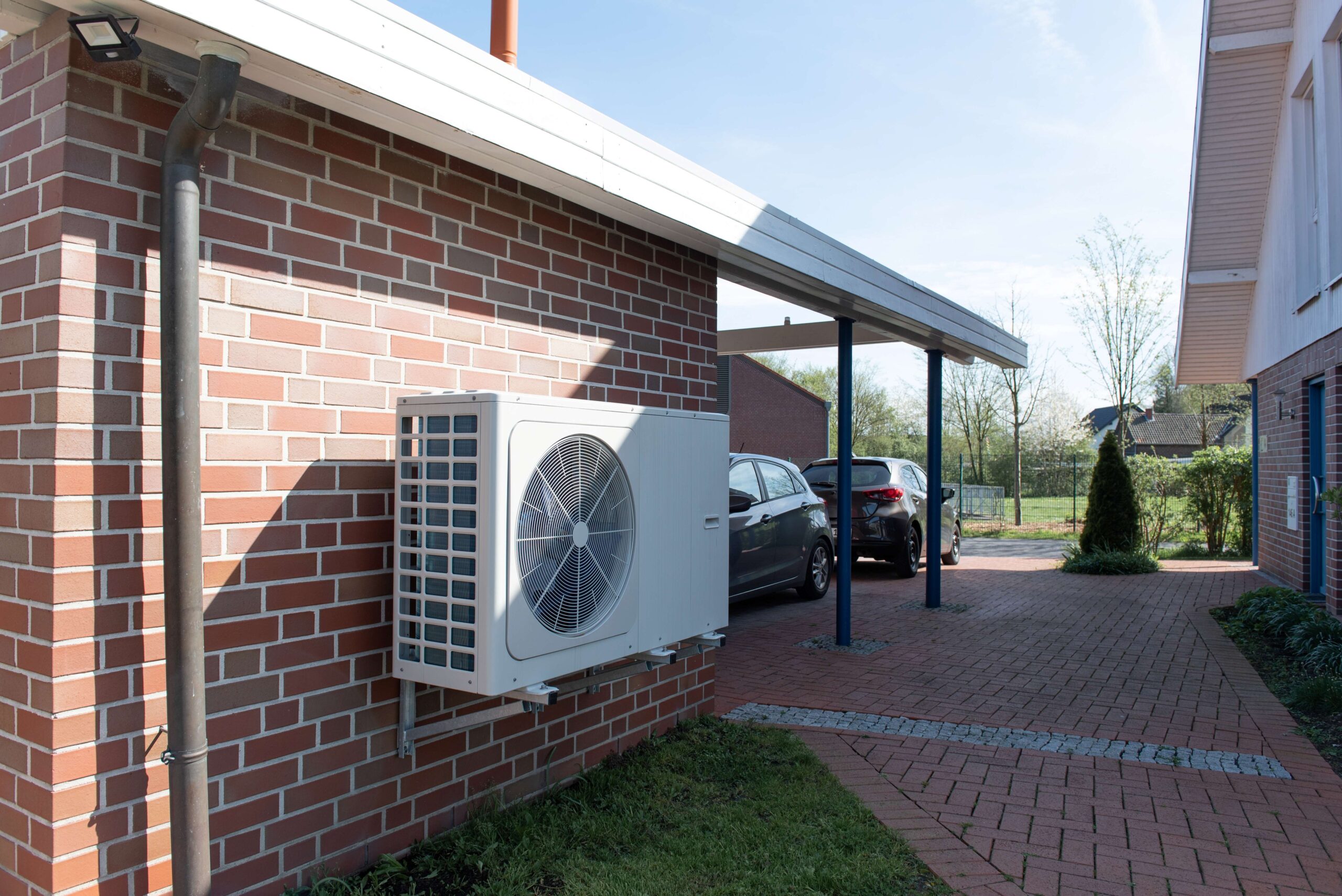 Photo of a heat pump installed on a house
