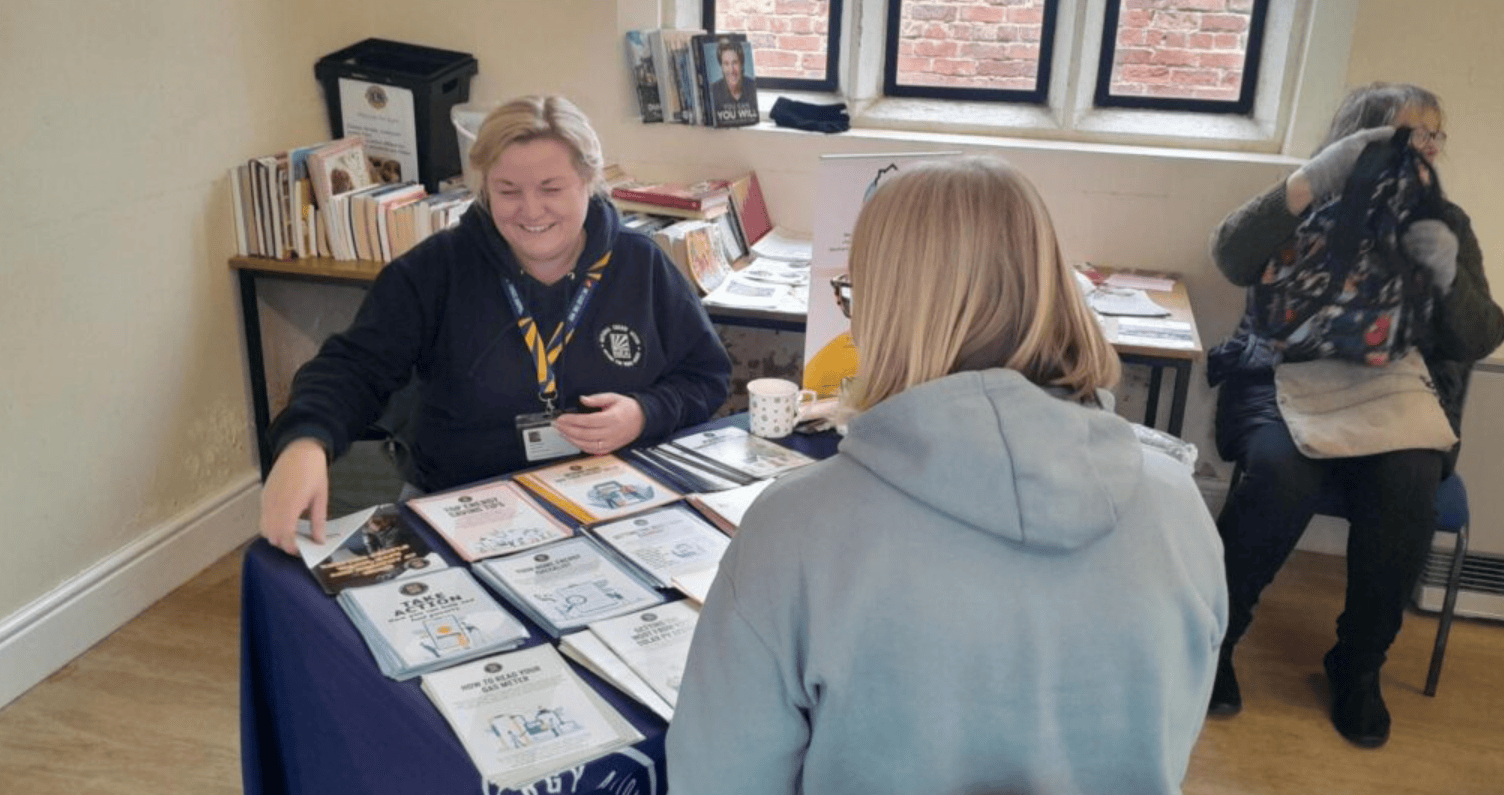 A photo of a National Energy Action adviser giving energy advice to a vulnerable client.